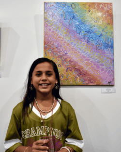 Amelia-Rose Prasad with her artwork 'In My Brain' at the Shapes exhibition opening.